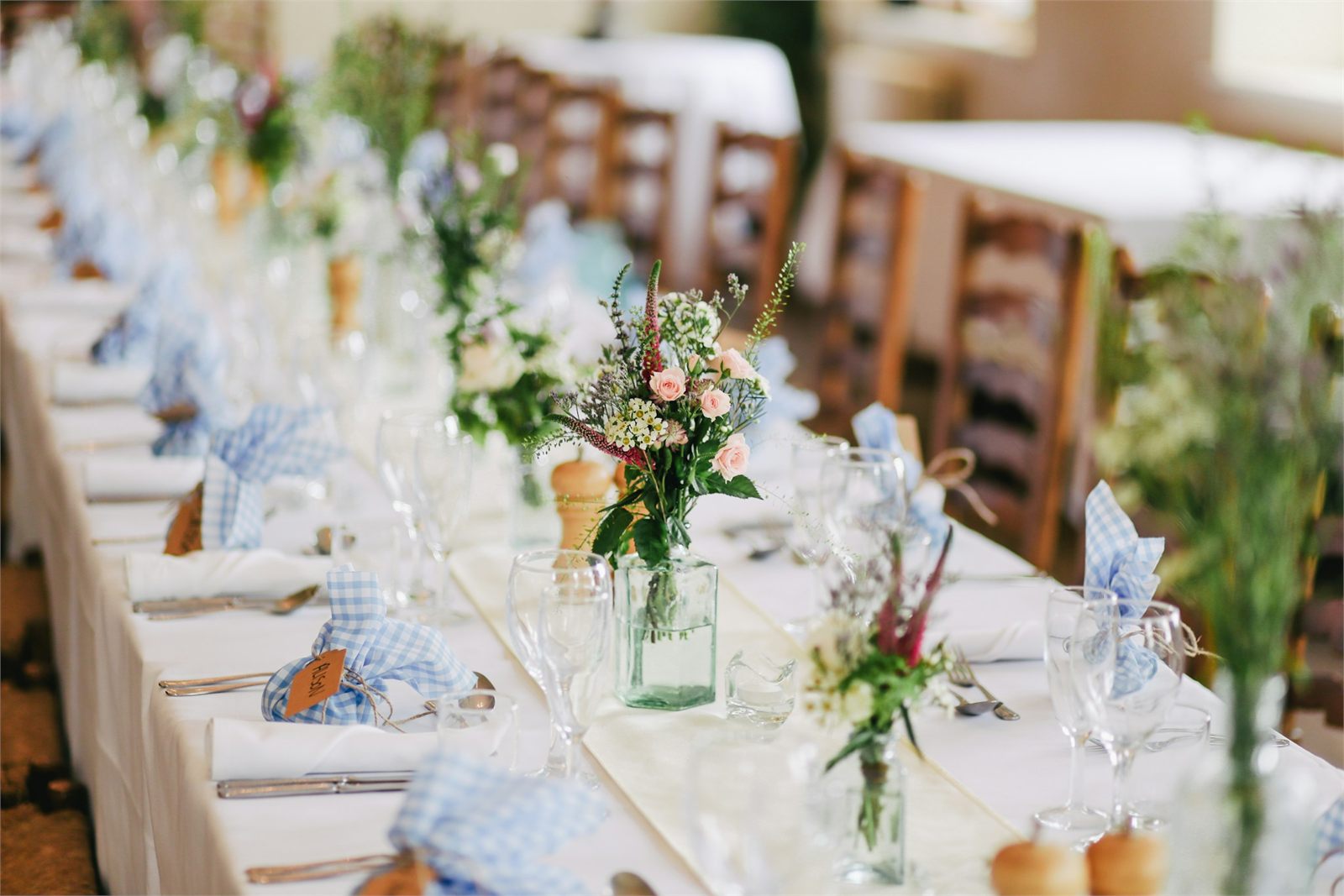 Polished glassware set out along a banquet table before service