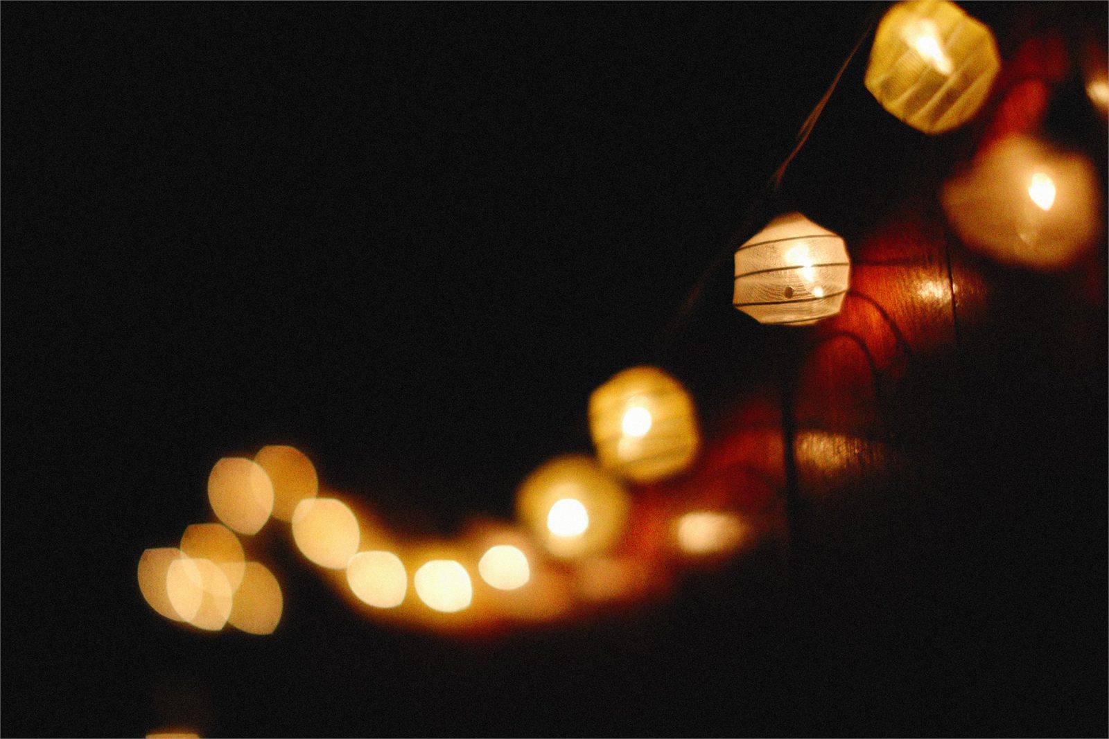 Warm lanterns glowing against a dark background