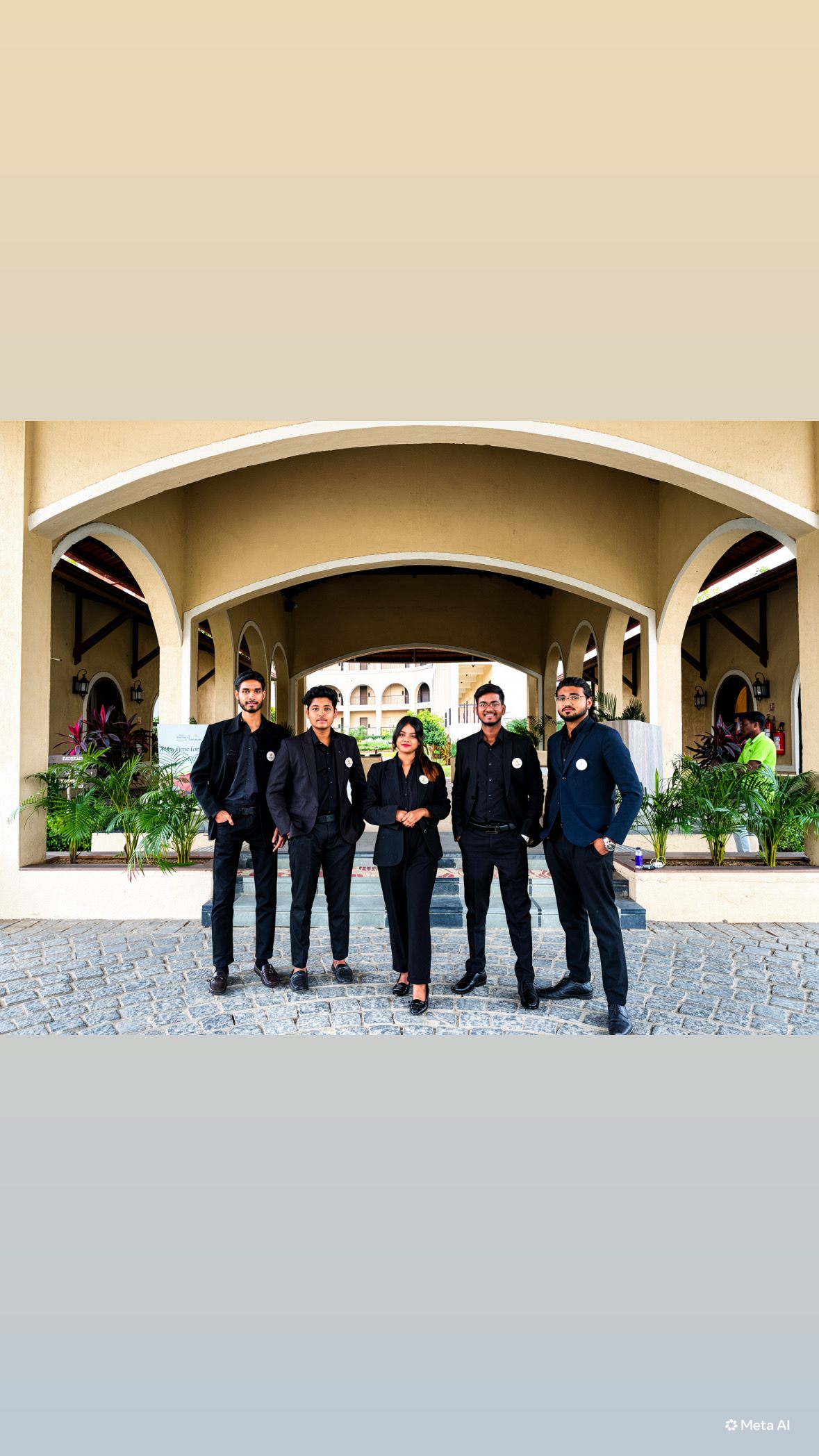 Five Indraa Events crew members standing under an arched stone colonnade during the day